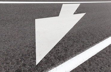asphalted road with arrows