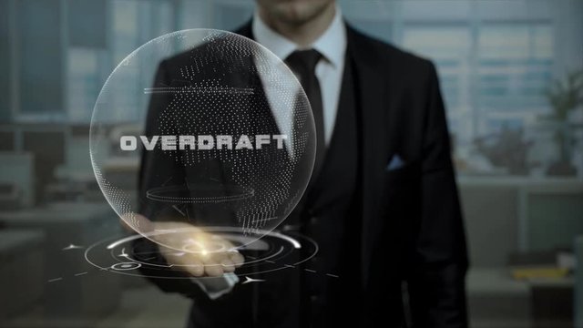 Male banker holds animated cyber Earth with word Overdraft in the office. Virtual hologram turns on the hand of entrepreneur.
