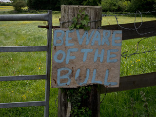 Beware of the bull sign on a pasture gate 