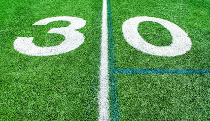 numbers marking the 30 yard line on an American football field