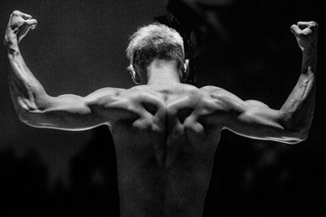 Fototapeta na wymiar strength and power.Pumped up guy kind of from the back.Strong hand.Silhouette photo