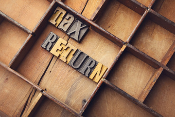 Tax return in wooden typeset letters