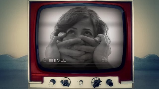 A retro vintage TV showing a CCTV security camera recording: a young woman attacked by someone that grabs her mouth with his hands. Close-up shot.
