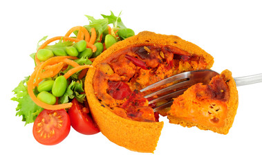 Chorizo and manchego cheese filled savoury quiche with fresh salad isolated on a white background