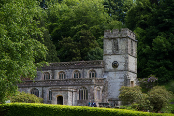 Fototapeta na wymiar Old English castle church in a verdant English Garden
