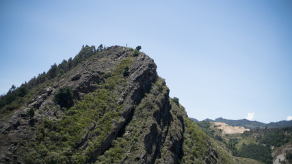 Fototapeta na wymiar Green mountain in a blue sky