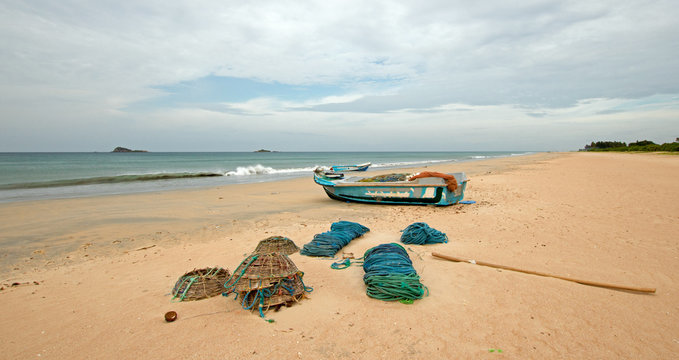 Nets and ropes next to fishing boat on Nilaveli beach in Trincomalee Sri Lanka