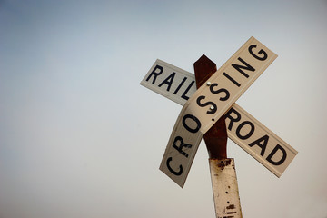 old worn and rusted railroad crossing sign