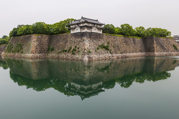 Osaka castle walls reflecting in water