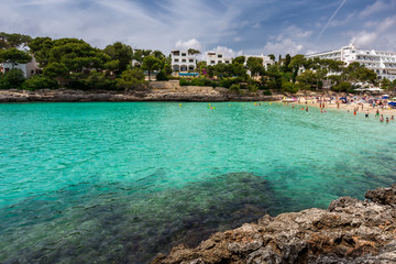Crowded beach Cala Gran in Cala d'Or, Mallorca during summer season