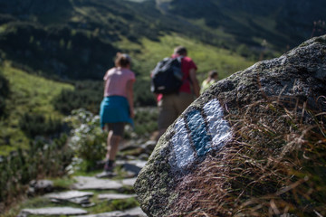 Young man hiking into the mountains