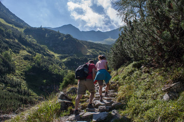 Young man hiking into the mountains