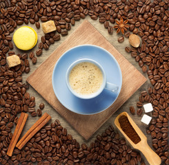 cup of coffee and beans on wooden background