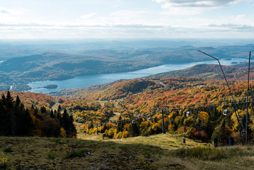 This is a picture of autumn leaves at Mont-Tremblant in the Laurentian plateau in Quebec, Canada. It is a scenery from Mont-Tremblant mountain. It is very beautiful with red and orange.