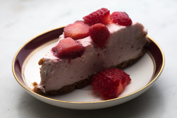 slice of strawberry cheesecake on white background, selective focus