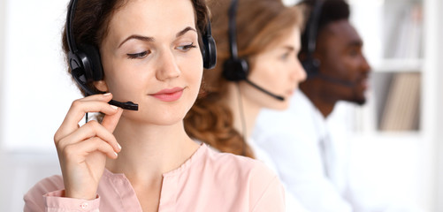 Call center operator.Young beautiful  brunette woman in headset. Business concept