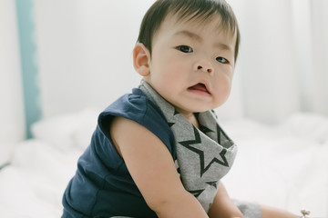 Portrait of a baby on the bed. Happy and fun.