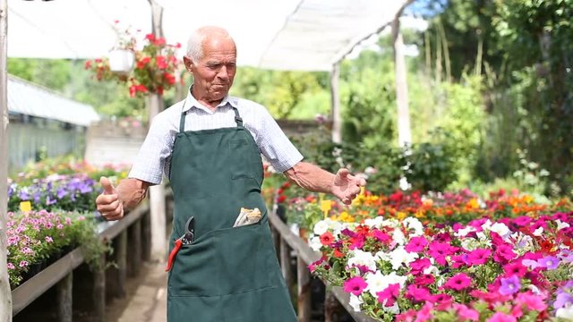 Portrait of cheerful elderly amateur gardener in his homestead outdoors 