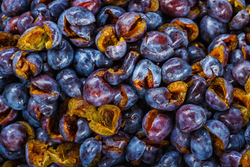 Background of fresh ripe peeled plums