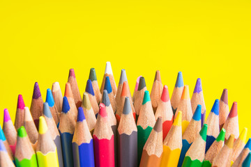 Back to school set multicolored pencils colorful making forms side view on a yellow backround.