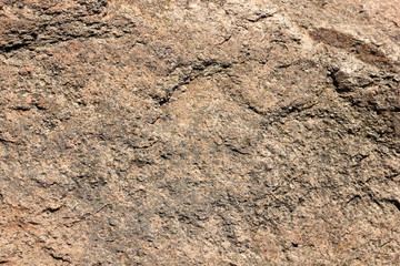 Granite background. Granite stone close up. Texture of natural material. Rocky rocks of ancient times. Natural pattern