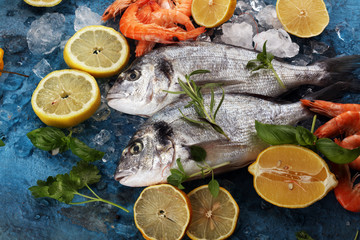 Delicious fresh fish. Fish with aromatic herbs, spices and vegetables - healthy food, diet or cooking concept.