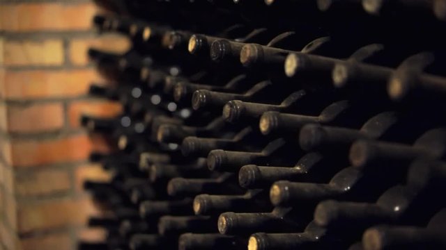 Corridor from wine cellar with dusty bottles of wine. Italy wine celler. 4K (UHD).