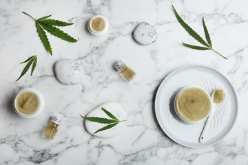 Flat lay composition with hemp lotion on marble background