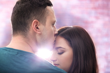Portrait of young loving couple on blurred background