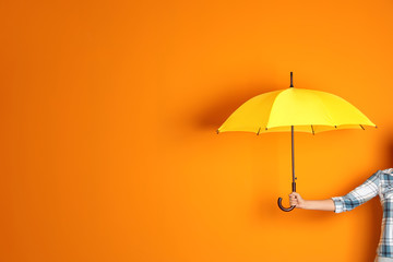 Woman holding beautiful umbrella on color background with space for design