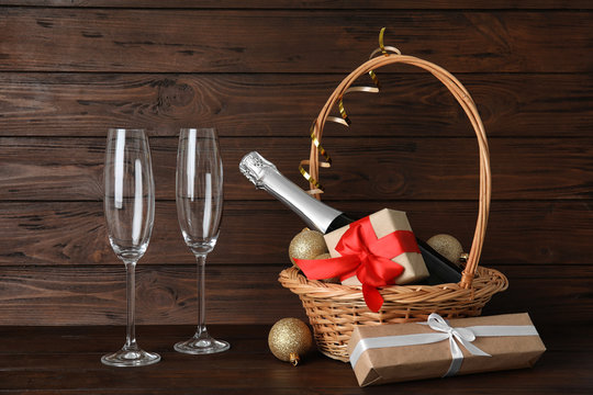 Christmas composition with bottle of champagne and glasses on wooden background