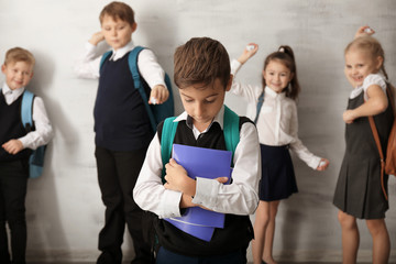 Children bullying their classmate indoors