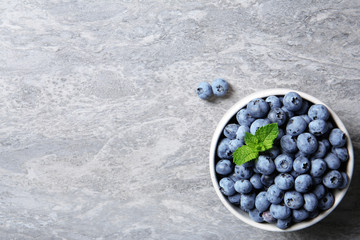 Crockery with fresh blueberries and space for text on table, top view