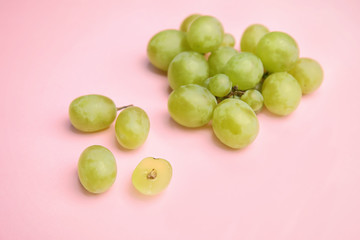 Fresh ripe juicy grapes on color background