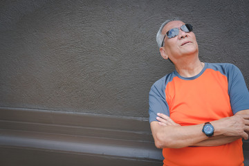 elder man standing with arms crossed. elderly male thinking. senior leisure lifestyle