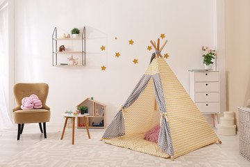 Cozy kids room interior with play tent and toys