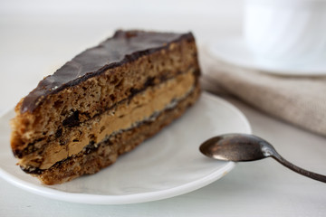 Tasty piece of chocolate cake on wooden table background