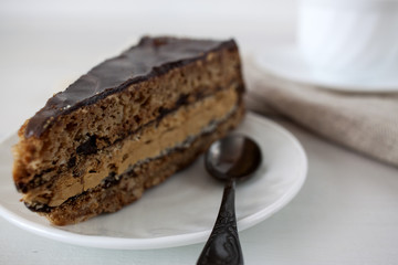 Tasty piece of chocolate cake on wooden table background