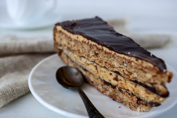 Tasty piece of chocolate cake on wooden table background