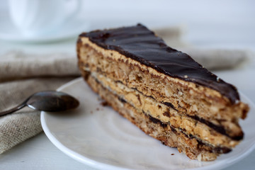 Tasty piece of chocolate cake on wooden table background