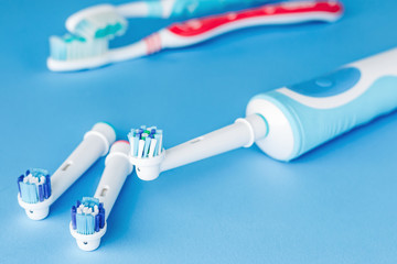 Electric and manual toothbrush  on blue background