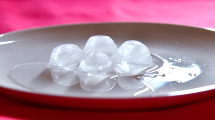 Ice melting on white plate, Thailand. - Powered by Adobe