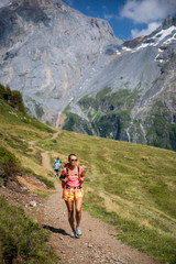 Naklejka na ściany i meble Pretty, female hiker/climber in a lovely alpine setting of Swiss Alps