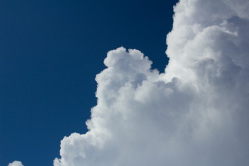 white cumulus cloud on dark blue sky before the storm