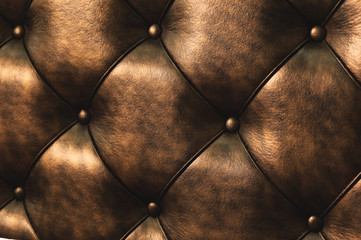 Surface of a rhombic split skin with buttons on the back of the bed. Rhombic patterns of bulk skin brown. Overflowing casing surface