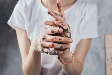 Closeup of woman's hands with paint, artist or creativity concept