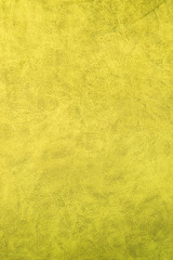 Yellow patterned surface of velvet fabric on top. Texture of artificial cloth
