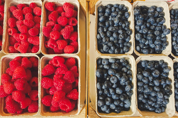 top down view on boxes of raspberries and blueberries
