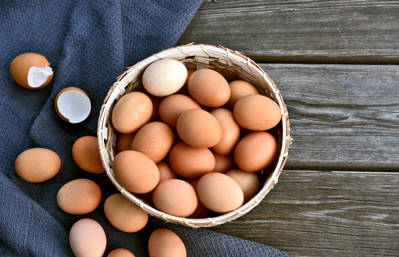 Healthy and benefits of chicken egg..Many chicken eggs in basket on wooden background.