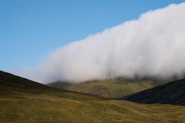 View of hills in Scottish Highlands on a clear summer's day, with low lying cloud. Photographed early in the morning near Inverness